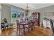 Elegant dining room with hardwood floors, large windows, and plenty of natural light at 5595 Godwin Lake Rd, Benson, NC 27504