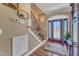 Charming entryway boasts a decorative front door, elegant staircase, and hardwood floors at 5595 Godwin Lake Rd, Benson, NC 27504