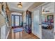 Inviting entryway showcasing hardwood floors, a stylish front door, and a view into the bedroom at 5595 Godwin Lake Rd, Benson, NC 27504
