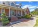 Inviting front exterior with brick facade, covered porch with columns, and professional landscaping enhance curb appeal at 5595 Godwin Lake Rd, Benson, NC 27504