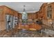 Spacious kitchen featuring custom wood cabinetry and high-end stainless steel appliances at 5595 Godwin Lake Rd, Benson, NC 27504