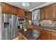 Updated kitchen with modern stainless steel appliances, stylish backsplash, and wood cabinets at 5595 Godwin Lake Rd, Benson, NC 27504