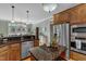 Elegant kitchen featuring granite counters, stainless appliances, and a center island for added prep space at 5595 Godwin Lake Rd, Benson, NC 27504