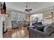 Cozy living room features plush seating, hardwood floors, and a view into dining area at 5595 Godwin Lake Rd, Benson, NC 27504