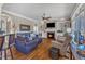 Inviting living room features a fireplace, built-in shelving, and a view to the kitchen at 5595 Godwin Lake Rd, Benson, NC 27504