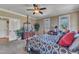 Spacious bedroom featuring a four-poster bed, neutral walls, and plenty of natural light from the large windows at 5595 Godwin Lake Rd, Benson, NC 27504