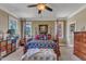 Inviting bedroom featuring a four-poster bed, a sitting area, and plush carpeting, perfect for relaxation at 5595 Godwin Lake Rd, Benson, NC 27504