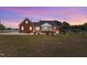 Rear view of home with lawn, featuring a screened porch and lush green lawn at 5595 Godwin Lake Rd, Benson, NC 27504