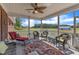 Inviting screened porch with comfortable seating, ceiling fan, and views of the serene surroundings at 5595 Godwin Lake Rd, Benson, NC 27504