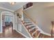 Elegant staircase featuring hardwood steps, iron railings, and access to the upper level at 5595 Godwin Lake Rd, Benson, NC 27504