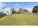 The house has a big backyard with a wooden fence surrounding the perimeter at 5745 Spence Farm Rd, Holly Springs, NC 27540