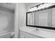Well-lit bathroom featuring a vanity and a shower-tub combination at 5745 Spence Farm Rd, Holly Springs, NC 27540