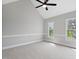 Bright bedroom featuring vaulted ceiling, carpet, trim and two large windows at 5745 Spence Farm Rd, Holly Springs, NC 27540