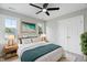 Cozy bedroom with a plush rug, bedside tables, and a large window at 5745 Spence Farm Rd, Holly Springs, NC 27540