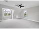 A bedroom with a vaulted ceiling, big windows, and neutral carpet at 5745 Spence Farm Rd, Holly Springs, NC 27540