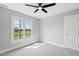 Bright bedroom featuring a ceiling fan and a large window with natural light at 5745 Spence Farm Rd, Holly Springs, NC 27540
