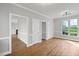 Spacious living room featuring hardwood floors, modern trim and a large window at 5745 Spence Farm Rd, Holly Springs, NC 27540