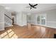 Open-concept living room featuring hardwood floors and access to the backyard at 5745 Spence Farm Rd, Holly Springs, NC 27540