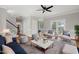 Comfortable living room with a ceiling fan, hardwood floors, and a view of the staircase at 5745 Spence Farm Rd, Holly Springs, NC 27540