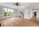 Spacious living room with hardwood floors, staircase, and abundant natural light at 5745 Spence Farm Rd, Holly Springs, NC 27540