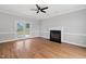 Inviting living room with a fireplace, hardwood floors, and access to the backyard at 5745 Spence Farm Rd, Holly Springs, NC 27540