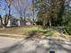 Fenced backyard with a well-maintained lawn and mature trees beyond the fence at 602 Dexter St, Rocky Mount, NC 27803