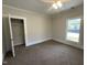 Bright bedroom featuring neutral walls, plush carpet, a ceiling fan, and a built-in closet at 602 Dexter St, Rocky Mount, NC 27803