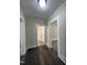 Hallway with freshly painted walls and flooring leads to bathroom and other rooms at 602 Dexter St, Rocky Mount, NC 27803