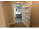 Hallway with open doorway to updated bathroom with sleek flooring and modern sink and vanity at 602 Dexter St, Rocky Mount, NC 27803