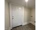 Neat utility room featuring durable plank flooring and a solid white door at 602 Dexter St, Rocky Mount, NC 27803
