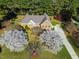 Stunning aerial view of brick home, mature trees, and a well-manicured front yard at 6521 Vintage Ridge Ln, Fuquay Varina, NC 27526