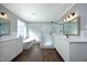 Luxurious bathroom with a glass-enclosed shower, a modern tub, dual vanities, and elegant fixtures at 6521 Vintage Ridge Ln, Fuquay Varina, NC 27526
