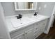 Bright bathroom featuring double sinks, modern fixtures, and white marble countertops at 6521 Vintage Ridge Ln, Fuquay Varina, NC 27526