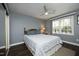 Comfortable bedroom featuring neutral walls, hardwood floors, ceiling fan, and natural light at 6521 Vintage Ridge Ln, Fuquay Varina, NC 27526