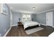 Spacious bedroom with natural light, hardwood floors, and a comfortable bed at 6521 Vintage Ridge Ln, Fuquay Varina, NC 27526