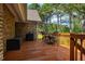 Cozy wood deck with grill, table, chairs, and storage, perfect for relaxing outdoors at 6521 Vintage Ridge Ln, Fuquay Varina, NC 27526