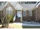 Inviting front entrance with brick steps, decorative plants, and stylish door at 6521 Vintage Ridge Ln, Fuquay Varina, NC 27526