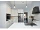 Chef's kitchen boasting custom white cabinetry, marble countertops, and stainless steel appliances at 6521 Vintage Ridge Ln, Fuquay Varina, NC 27526