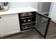 Wine fridge built into the cabinets with white countertops and stainless steel hardware at 6521 Vintage Ridge Ln, Fuquay Varina, NC 27526