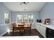 Dining area with a view of the backyard, open to the eat-in kitchen with hardwood floors at 6521 Vintage Ridge Ln, Fuquay Varina, NC 27526
