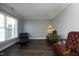 Cozy living room with hardwood floors, natural light, and stylish chairs at 6521 Vintage Ridge Ln, Fuquay Varina, NC 27526