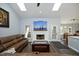 Bright living room with skylights, fireplace, and comfortable leather couch at 6521 Vintage Ridge Ln, Fuquay Varina, NC 27526