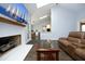 Spacious living room featuring a fireplace, skylights, and hardwood floors at 6521 Vintage Ridge Ln, Fuquay Varina, NC 27526