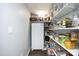 Spacious walk-in pantry with a refrigerator and ample shelving to maximize storage capacity at 6521 Vintage Ridge Ln, Fuquay Varina, NC 27526
