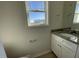 Bathroom featuring granite countertops, white cabinets, and a large mirror at 74 Harvest Hills Ln, Dunn, NC 28334