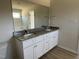 Bathroom features a double sink vanity with granite countertop and white cabinets, plus a large mirror at 74 Harvest Hills Ln, Dunn, NC 28334