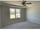Spacious primary bedroom featuring a ceiling fan and large window for natural light at 74 Harvest Hills Ln, Dunn, NC 28334