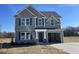 Charming two-story home featuring gray siding and a convenient attached one-car garage at 74 Harvest Hills Ln, Dunn, NC 28334