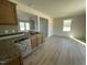 Modern kitchen with light wood cabinets, granite countertops and an open floorplan at 74 Harvest Hills Ln, Dunn, NC 28334