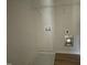 Laundry room with white walls, wood floor, and connections for washer and dryer at 74 Harvest Hills Ln, Dunn, NC 28334